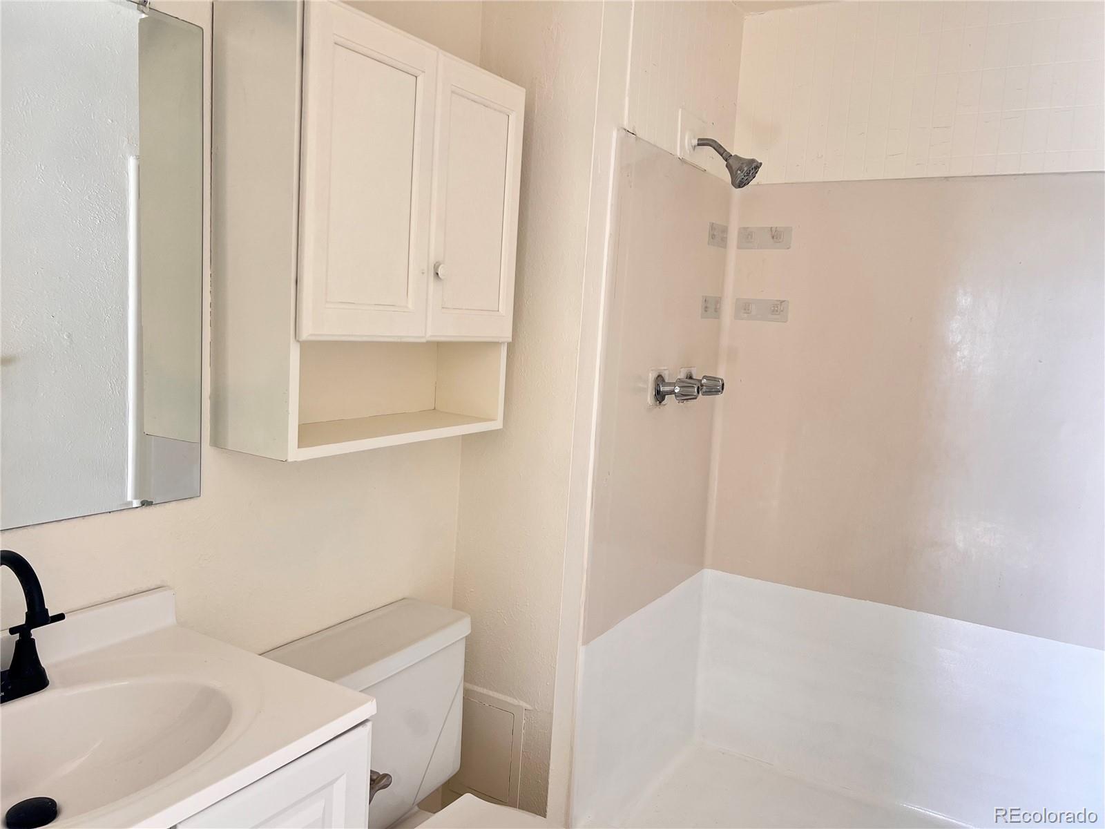 875 South Quebec Street, Unit 29 Denver, CO 80247 - Photo 7 of 13 a bathroom with a sink and a mirror