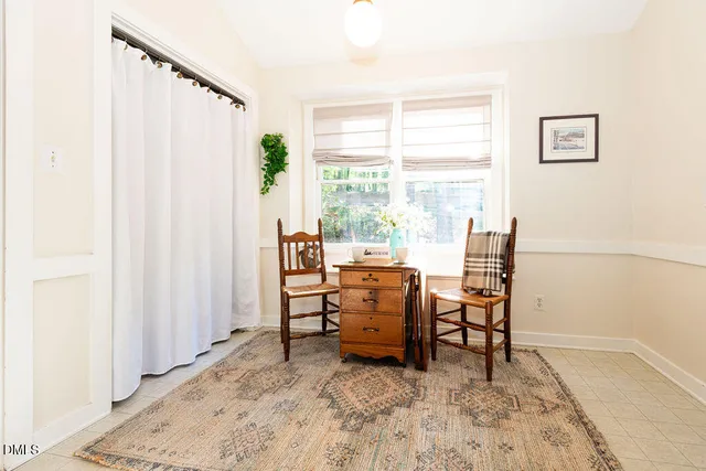 a view of a workspace with furniture and a window