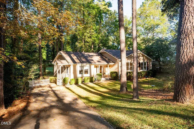 a view of a house with a yard balcony and tree s