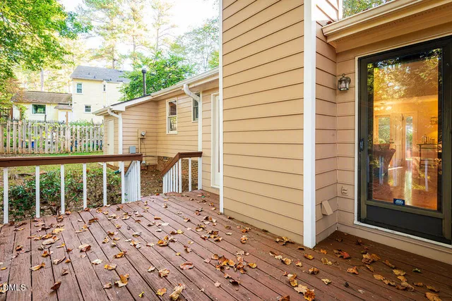 a view of a balcony with wooden floor and fence