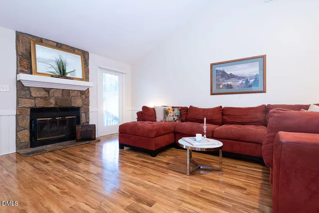 a living room with furniture a fireplace and a flat screen tv