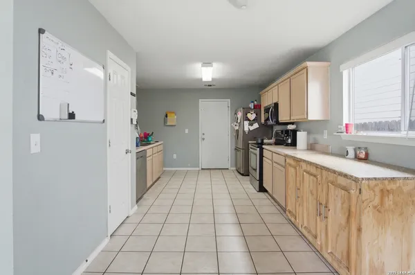 a kitchen with stainless steel appliances a sink and a refrigerator