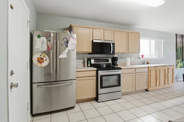 a kitchen with stainless steel appliances and white cabinets