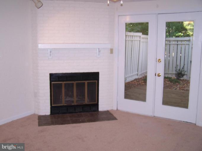 11930 Fieldthorn Court Reston, VA 20194 - Photo 11 of 12 a living room with a fireplace
