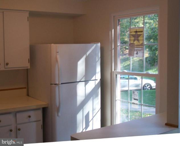 11930 Fieldthorn Court Reston, VA 20194 - Photo 3 of 12 a view of a kitchen with a fridge