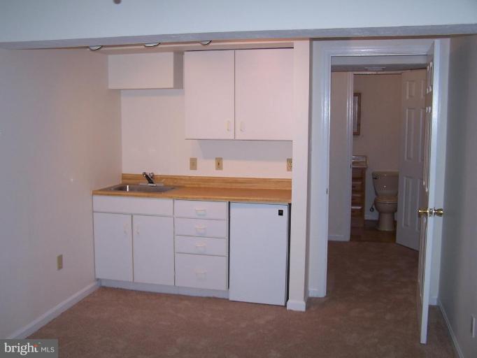 11930 Fieldthorn Court Reston, VA 20194 - Photo 10 of 12 a bathroom with a sink and a mirror