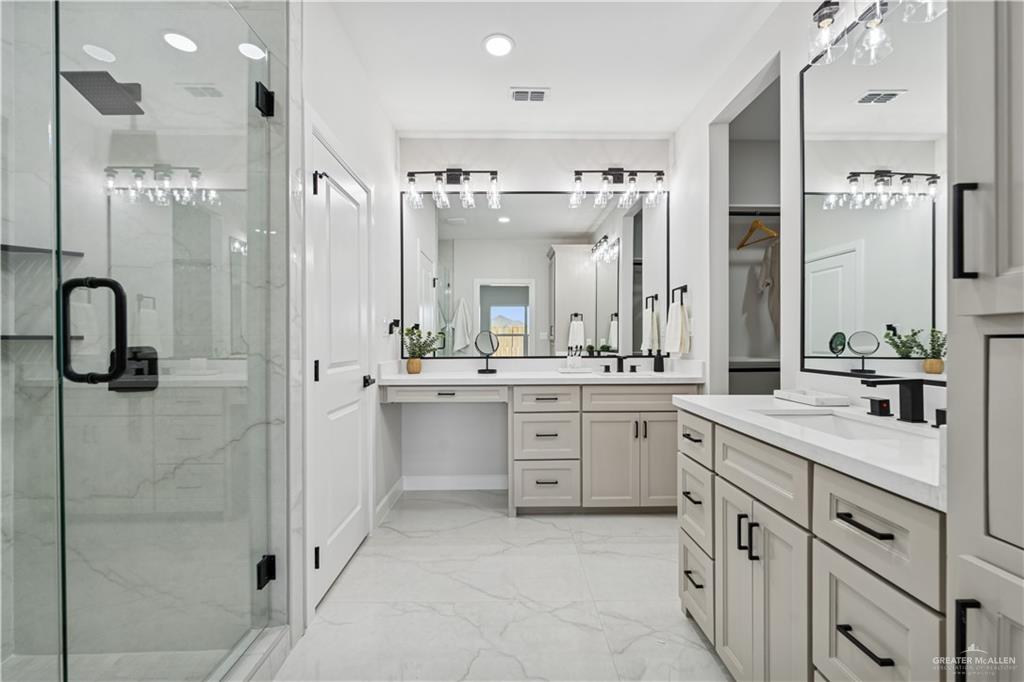 1013 Azalea Street Mission, TX 78573 - Photo 20 of 35 Full bath with two vanities, a marble finish shower, light marble finish flooring, and recessed lighting