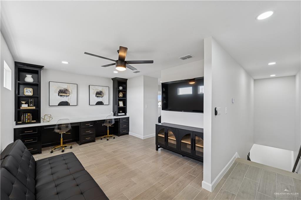 1013 Azalea Street Mission, TX 78573 - Photo 24 of 35 Living room with built in desk, wood finish floors, recessed lighting, and ceiling fan
