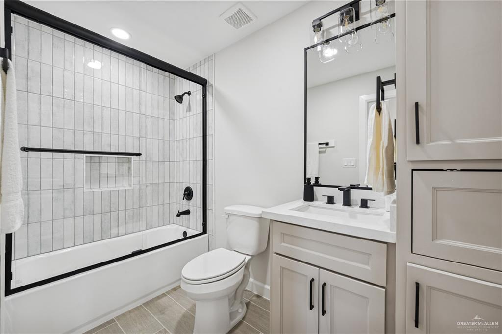 1013 Azalea Street Mission, TX 78573 - Photo 26 of 35 Bathroom featuring combined bath / shower with glass door, vanity, and recessed lighting