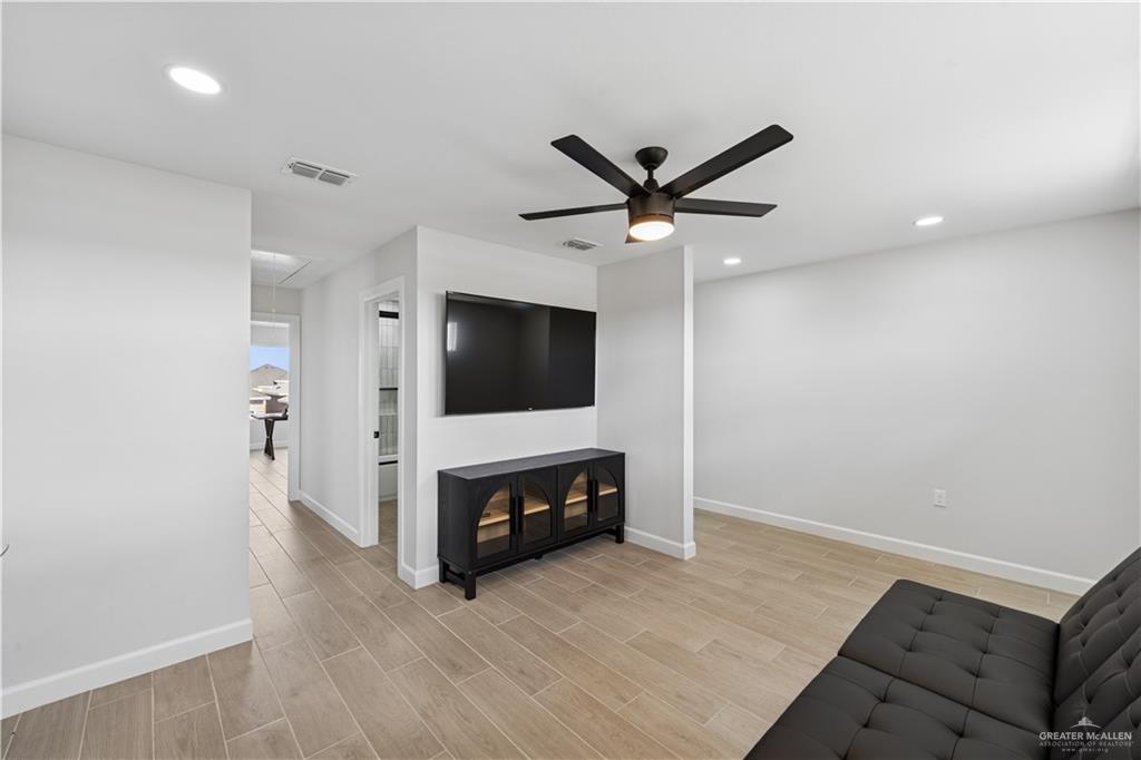 1013 Azalea Street Mission, TX 78573 - Photo 27 of 35 Unfurnished living room featuring attic access, wood finish floors, recessed lighting, and ceiling fan
