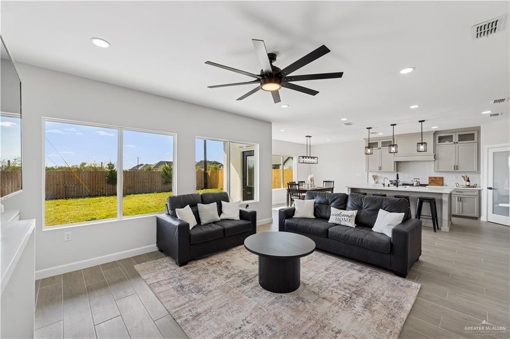 1013 Azalea Street Mission, TX 78573 - Photo 6 of 35 Living room featuring wood tiled floors, recessed lighting, and a ceiling fan