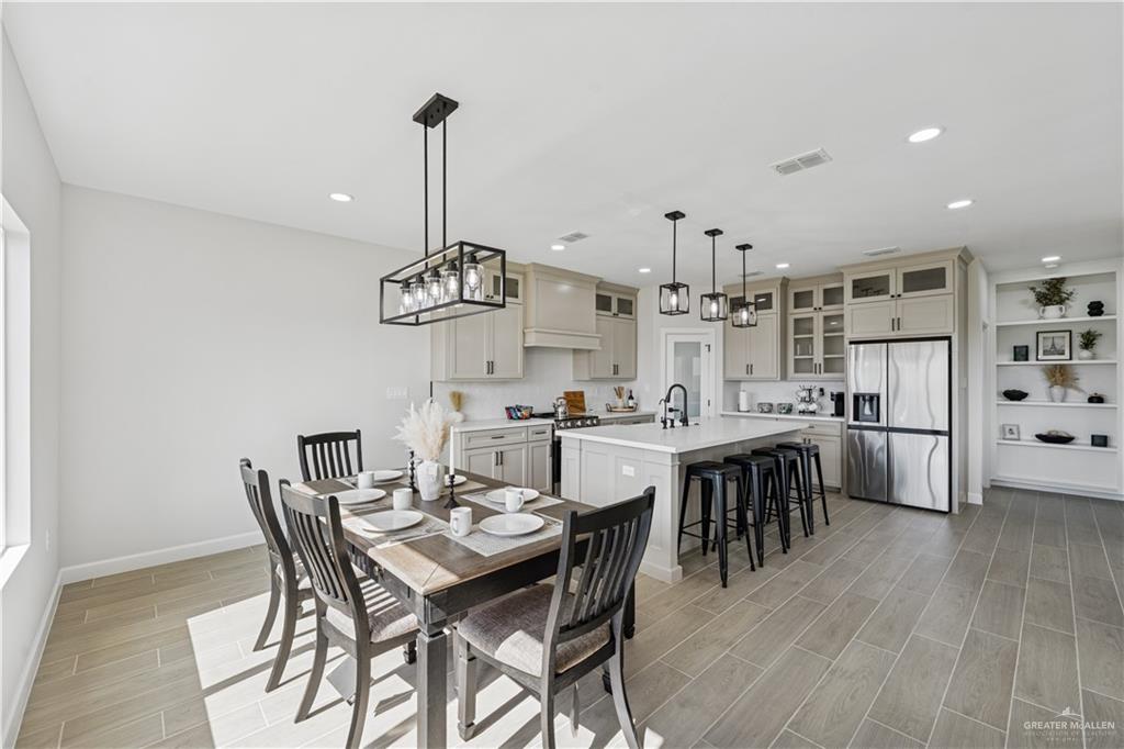 1013 Azalea Street Mission, TX 78573 - Photo 9 of 35 Dining area featuring a chandelier, wood tiled floors, and recessed lighting