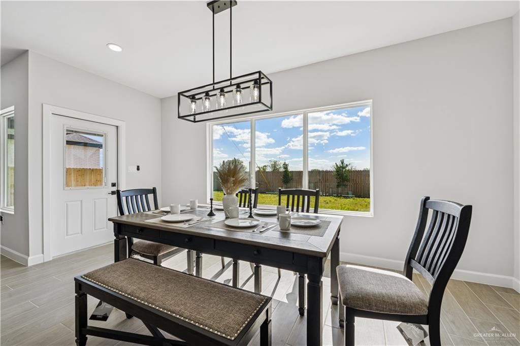 1013 Azalea Street Mission, TX 78573 - Photo 10 of 35 Dining space featuring wood tiled floors, plenty of natural light, and recessed lighting