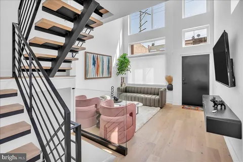 a bedroom with furniture and a large window