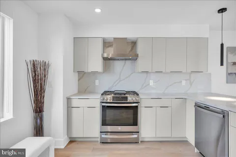 a kitchen with stainless steel appliances a stove and a refrigerator