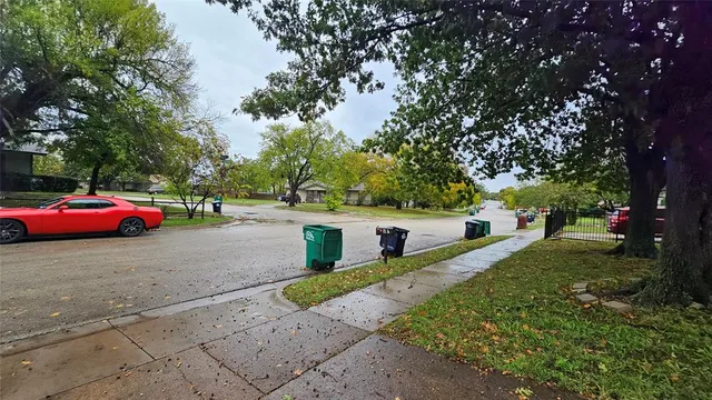 a view of a park with bench and trees