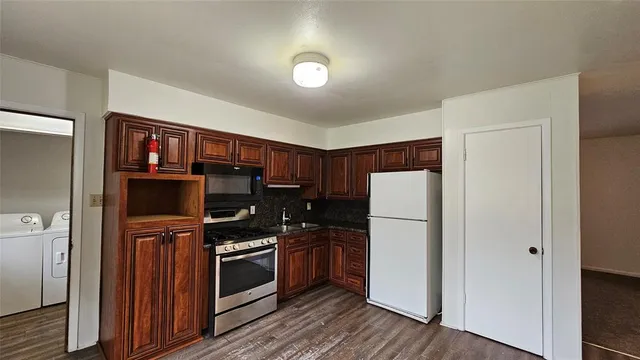 a bathroom with a sink a toilet a shower and mirror