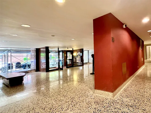 a view of a hallway with dining area and chandelier
