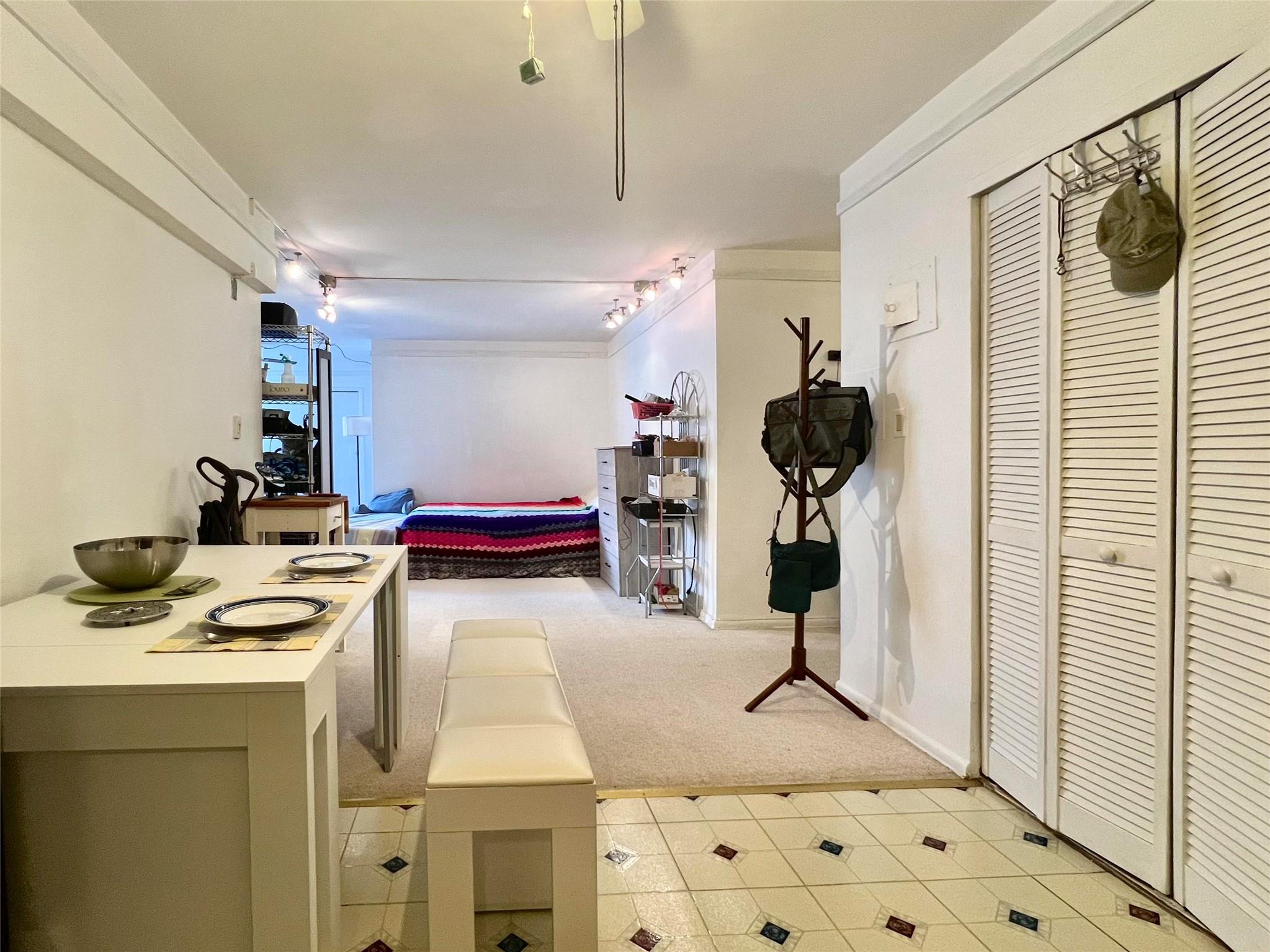 142-05 Roosevelt Avenue, Unit 301 Queens, NY 11354 - Photo 2 of 11 a kitchen with white cabinets and appliances