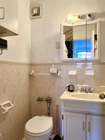 a bathroom with a sink a mirror and toilet