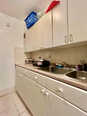 a kitchen with stainless steel appliances granite countertop a sink a stove and white cabinets