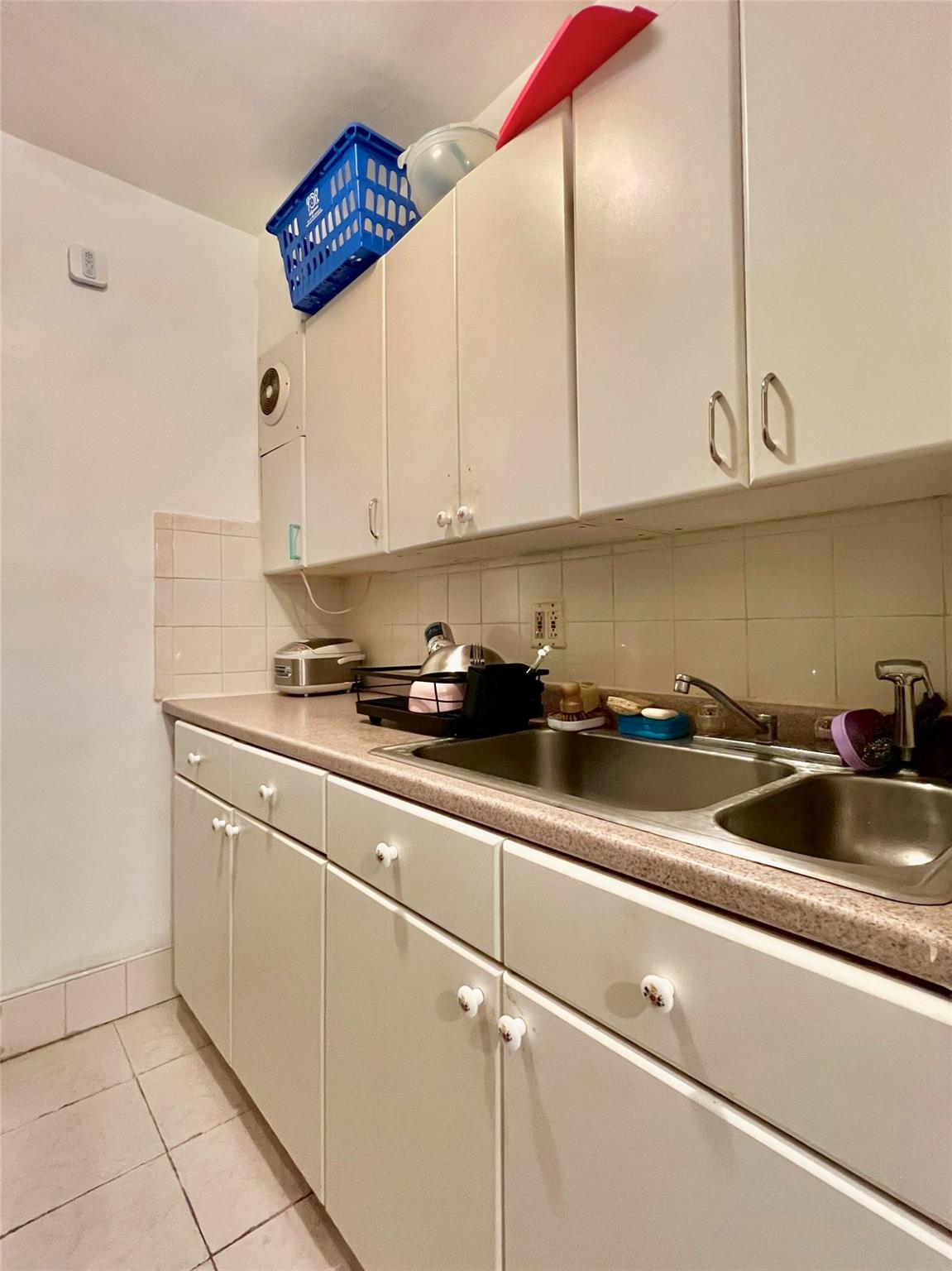 142-05 Roosevelt Avenue, Unit 301 Queens, NY 11354 - Photo 8 of 11 a kitchen with stainless steel appliances granite countertop a sink a stove and white cabinets