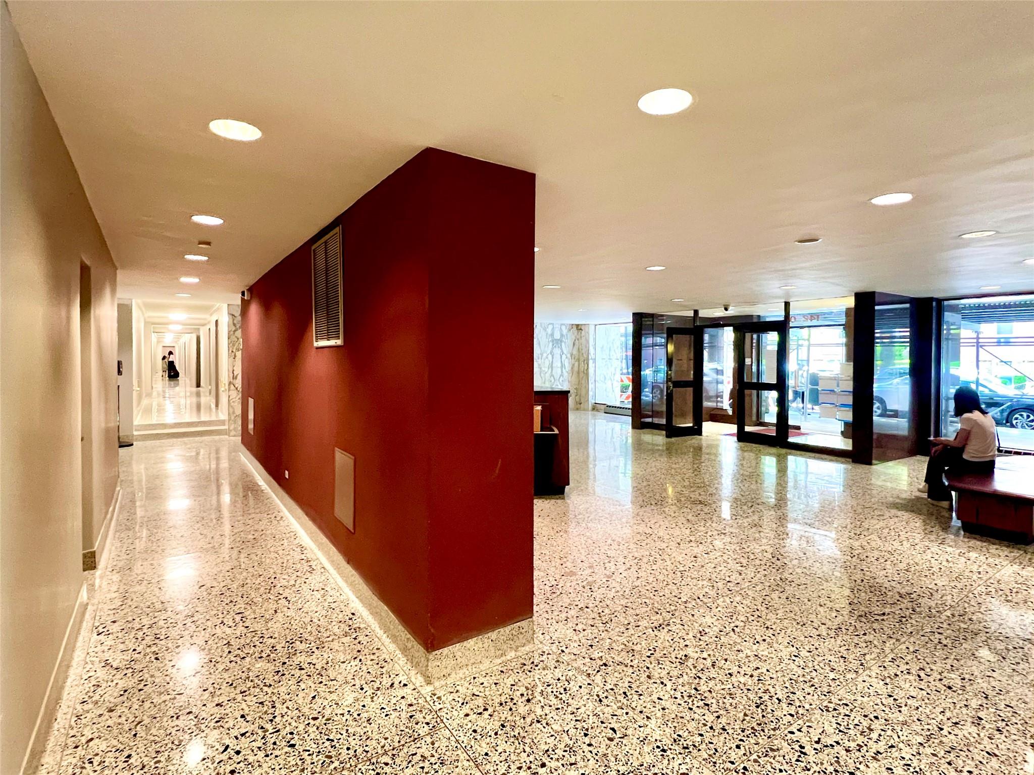 142-05 Roosevelt Avenue, Unit 301 Queens, NY 11354 - Photo 9 of 11 a view of a hallway with dining area and chandelier