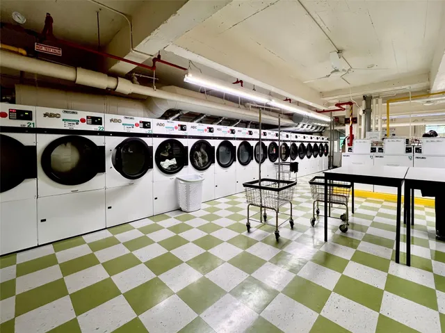 a utility room with stainless steel appliances and cabinets