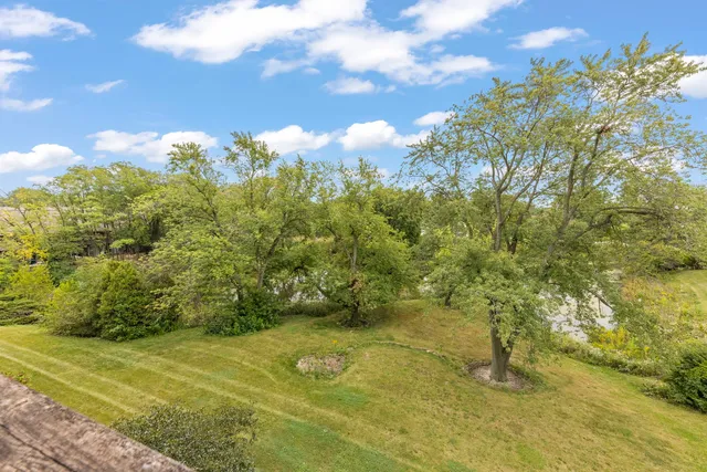 a very nice looking dining room with kitchen island stainless steel appliances a table and chairs