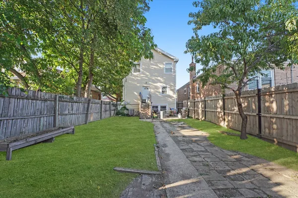 a view of a backyard with wooden fence