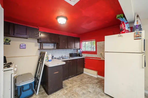 a kitchen with refrigerator and cabinets