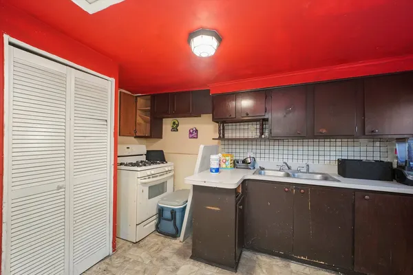 a kitchen with a sink a stove and cabinets