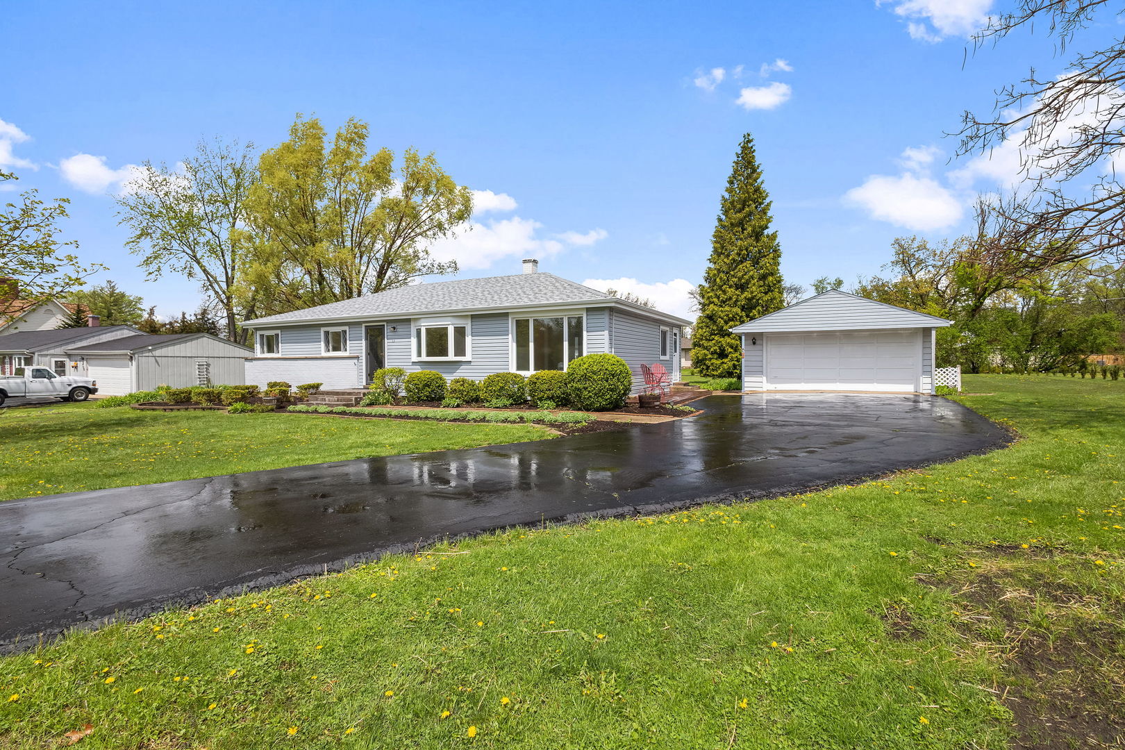 646 68th Street Willowbrook, IL 60527 - Photo 20 of 24 a front view of a house with a garden and lake view