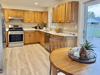 646 68th Street Willowbrook, IL 60527 - Photo 7 of 24 a kitchen with stainless steel appliances kitchen island granite countertop a sink a stove and a wooden floors