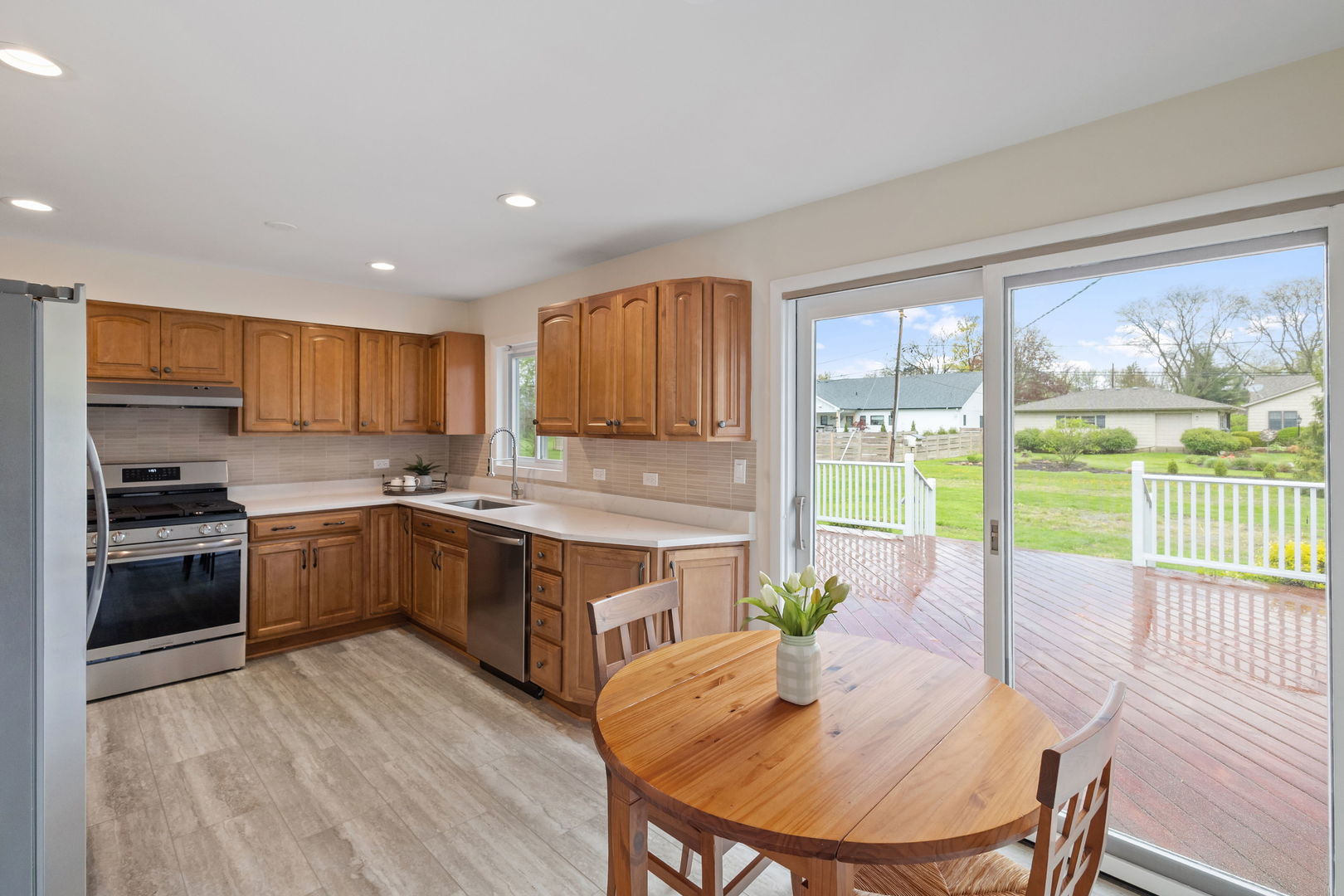 646 68th Street Willowbrook, IL 60527 - Photo 8 of 24 a kitchen with a table chairs stove and cabinets