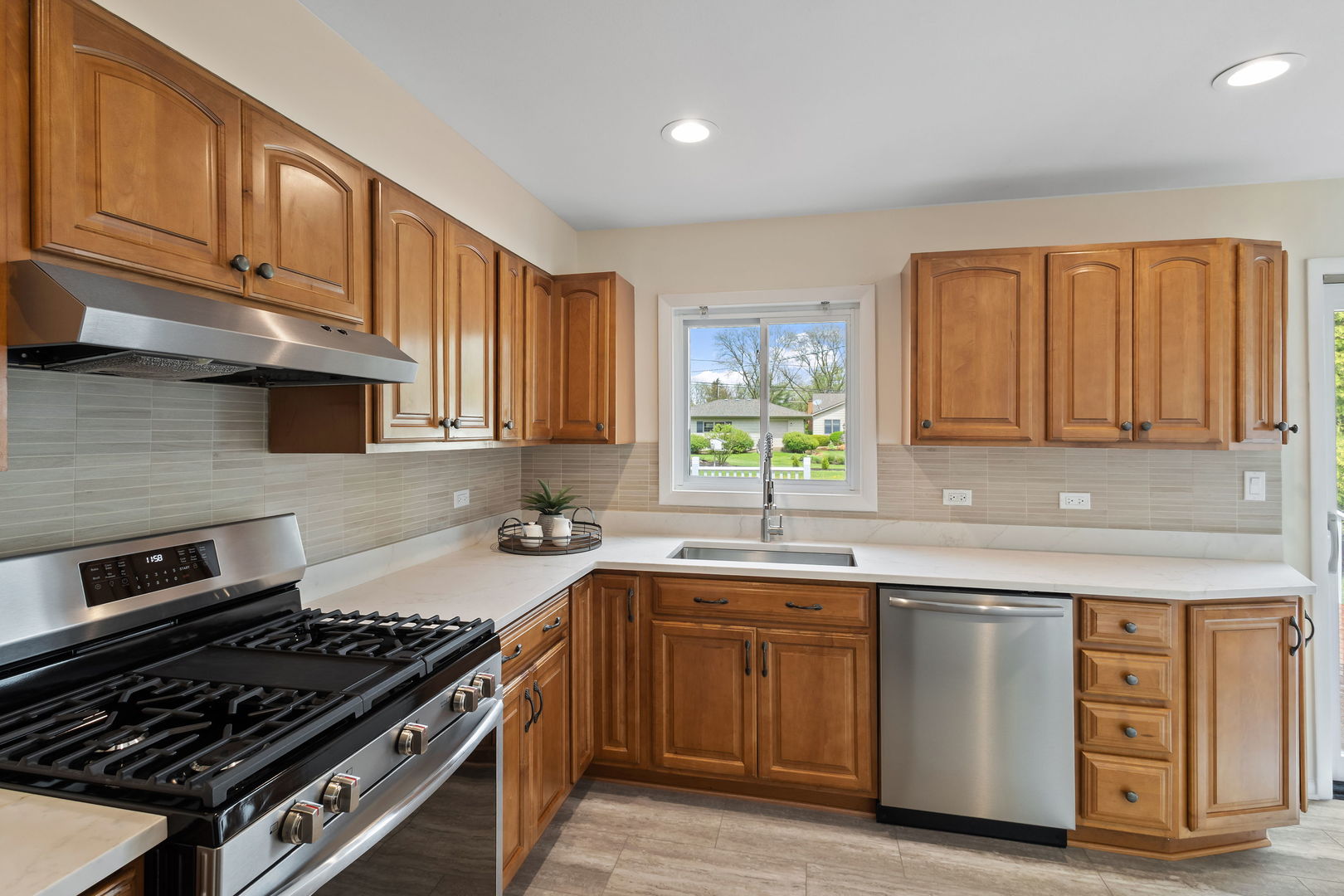 646 68th Street Willowbrook, IL 60527 - Photo 10 of 24 a kitchen with a sink stove top oven and cabinets