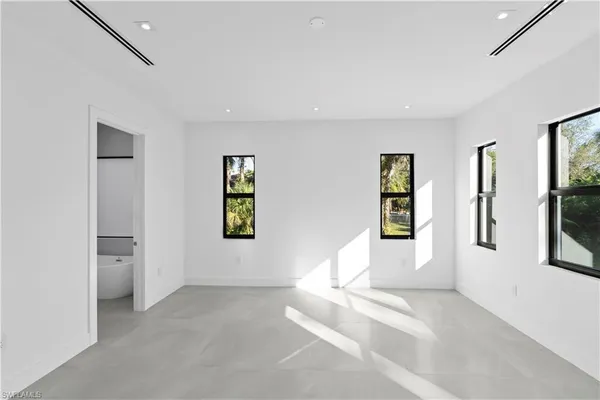 a white tub sitting next to a window