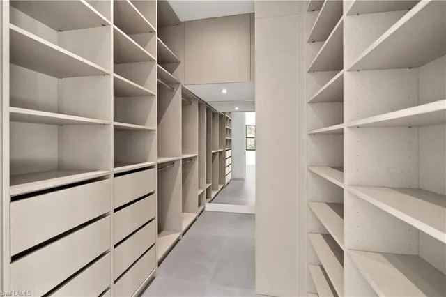 a white toilet sitting next to a white wall