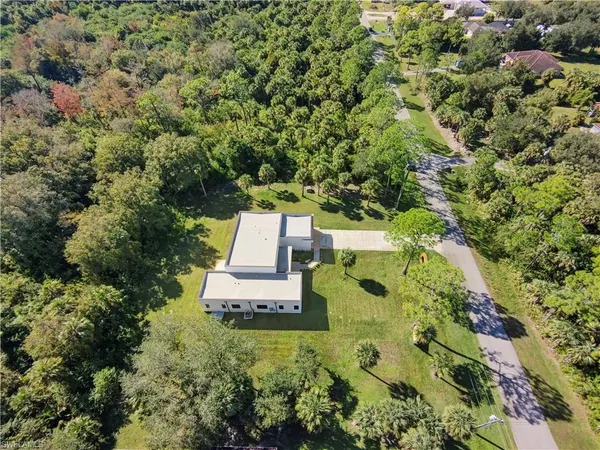 a white building with a yard in front of it