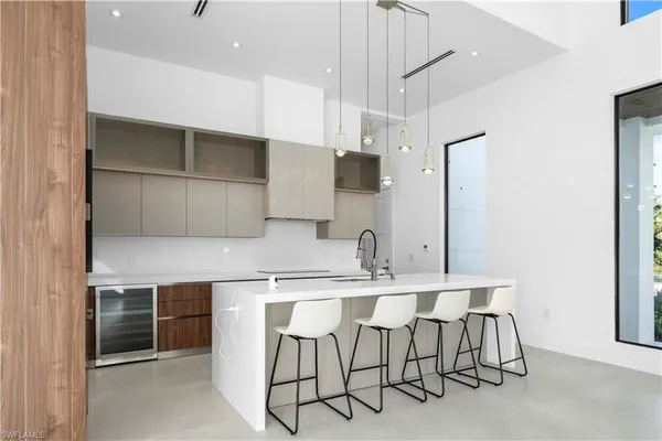 a kitchen with a table chairs refrigerator and microwave