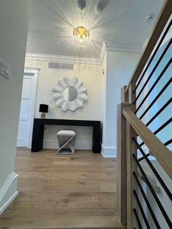 a dining room with furniture a chandelier and wooden floor