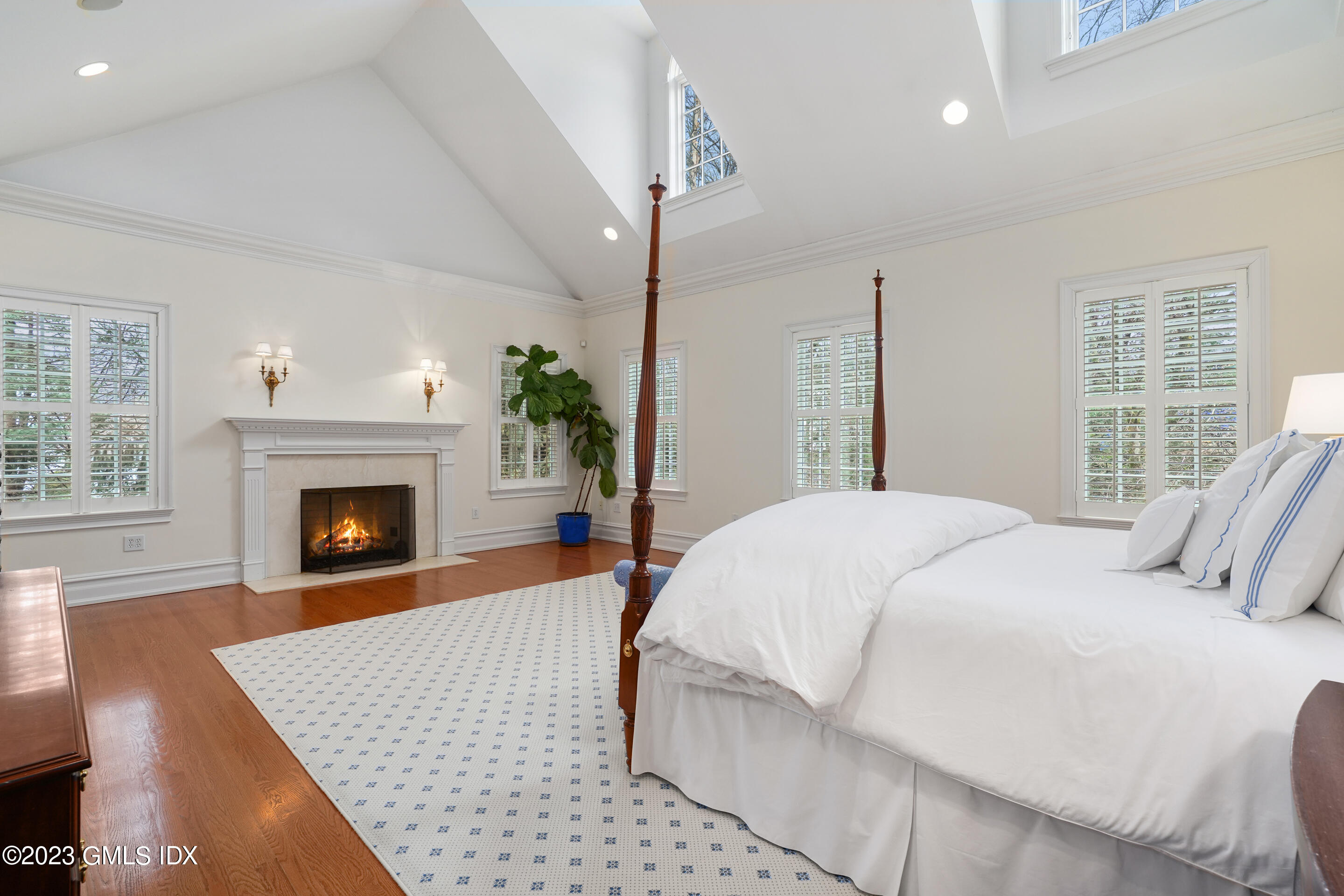 55 North Street Greenwich, CT 06830 - Photo 18 of 44 a bedroom with a bed and a fireplace