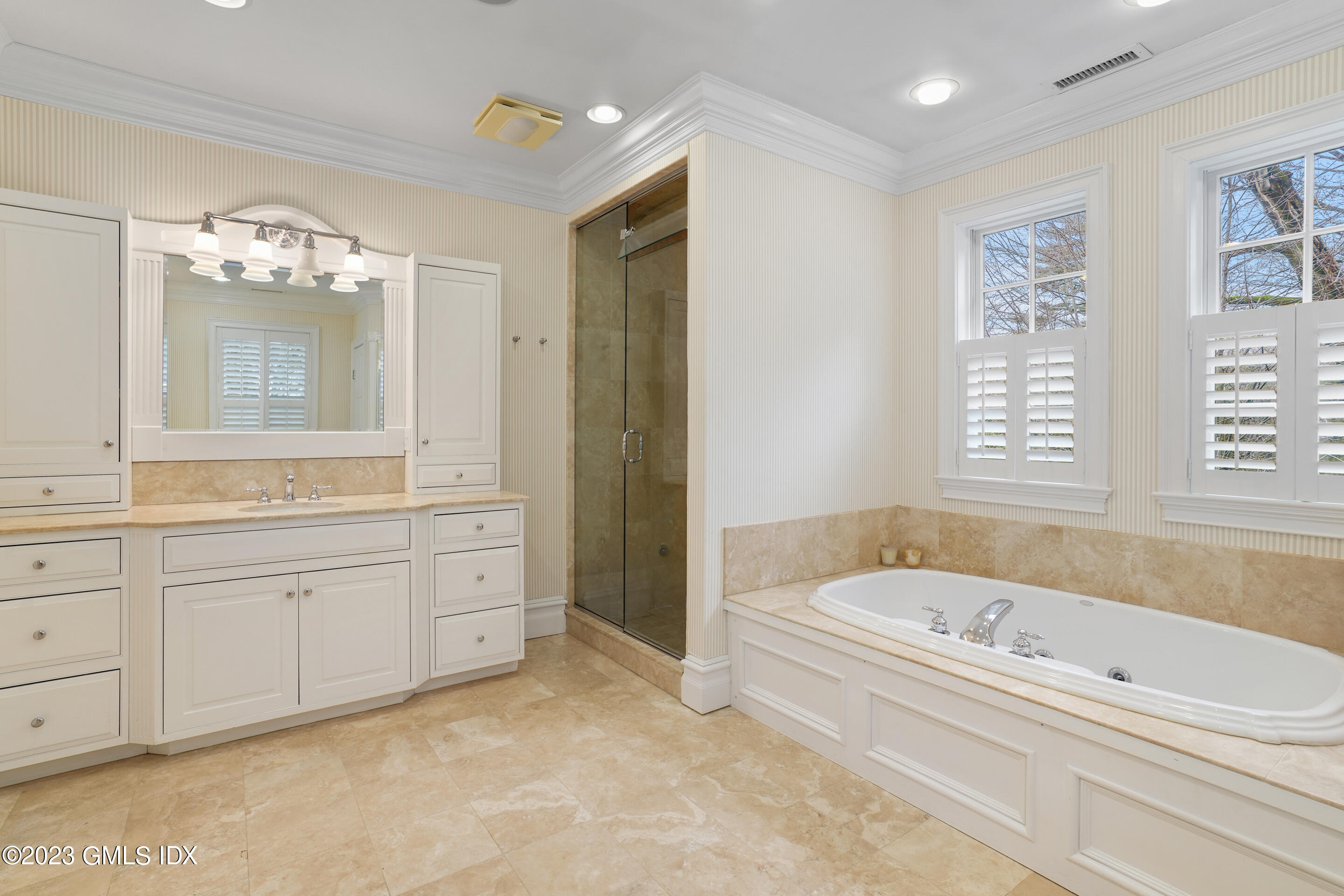 55 North Street Greenwich, CT 06830 - Photo 20 of 44 a bathroom with a bathtub sink and mirror