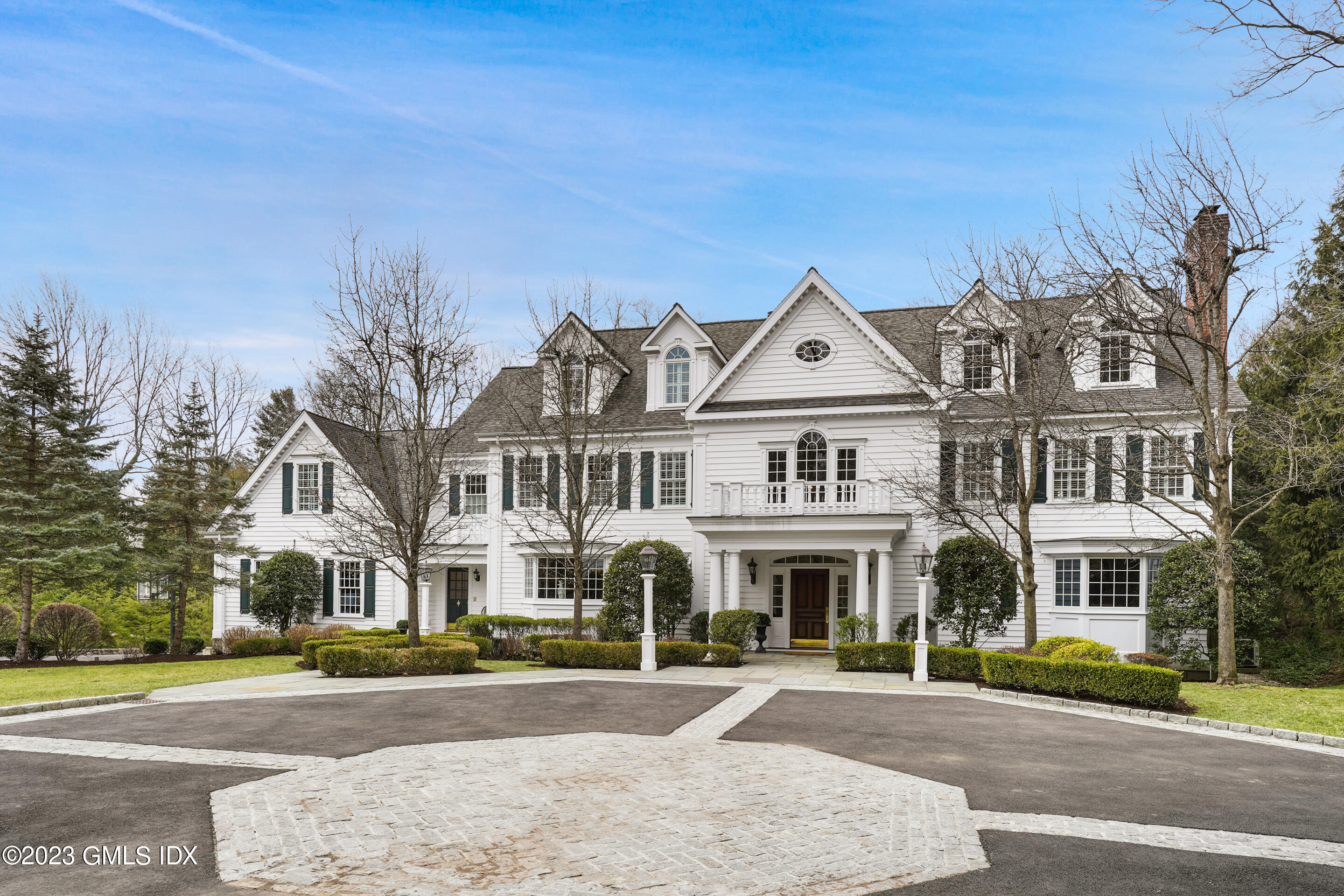 55 North Street Greenwich, CT 06830 - Photo 2 of 44 a front view of residential houses with yard and trees