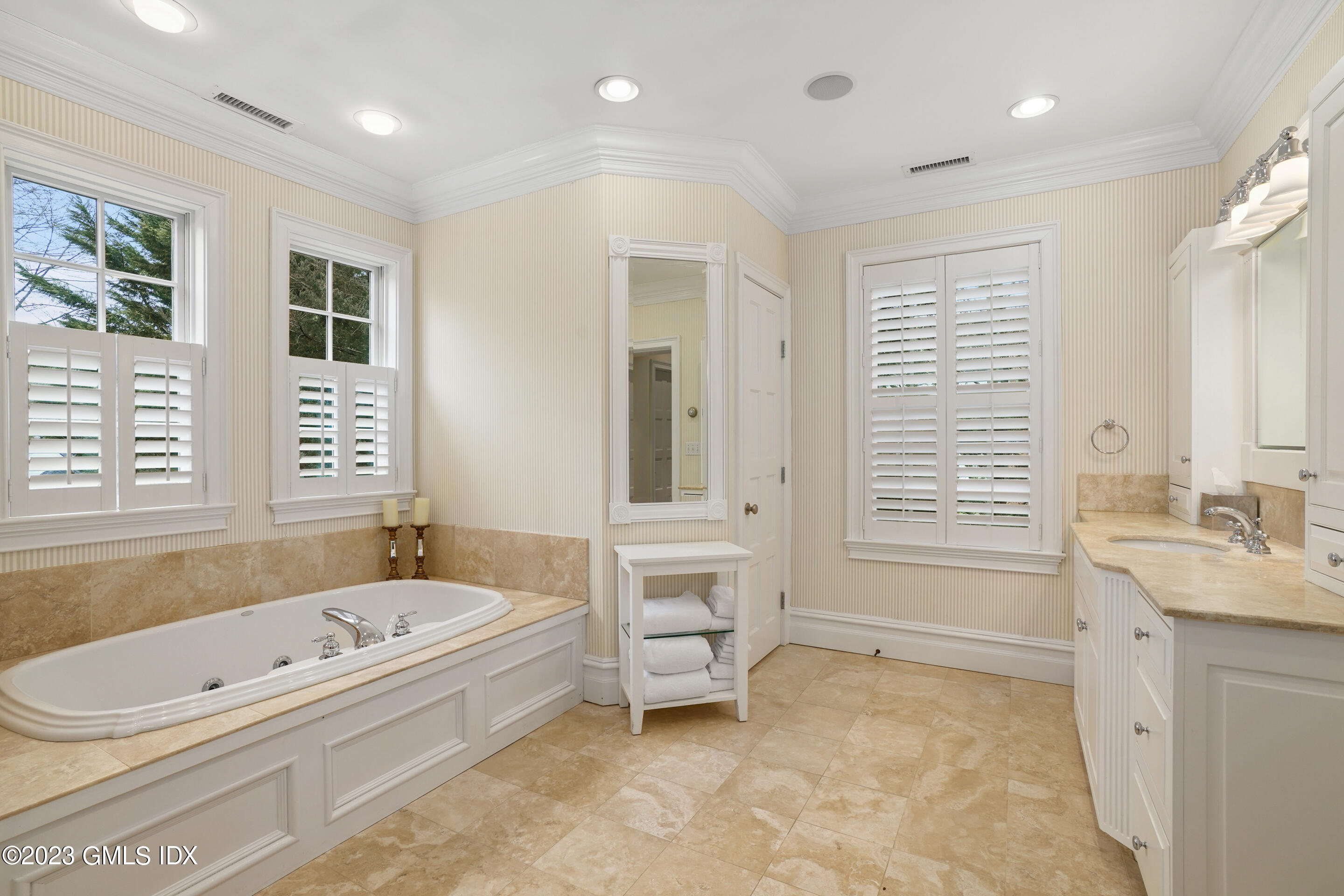 55 North Street Greenwich, CT 06830 - Photo 21 of 44 a bathroom with a bathtub a sink a vanity and a shower