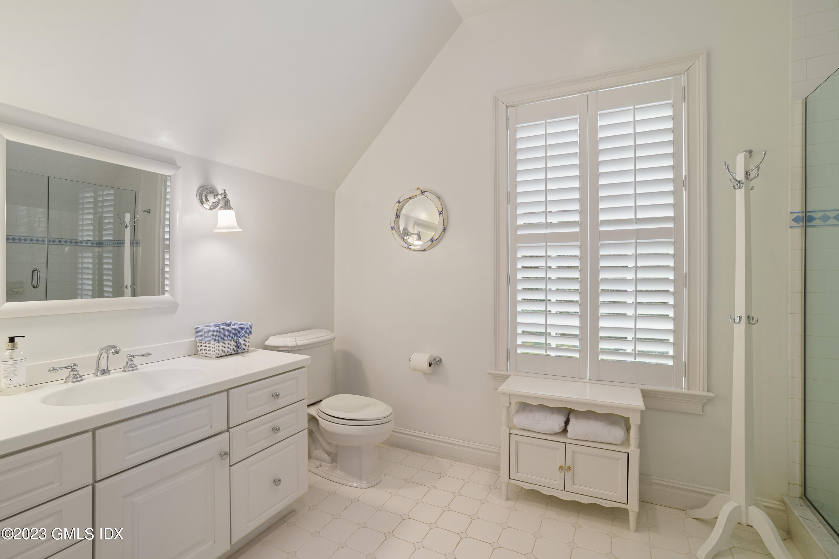 55 North Street Greenwich, CT 06830 - Photo 28 of 44 a spacious bathroom with a toilet a sink and a mirror