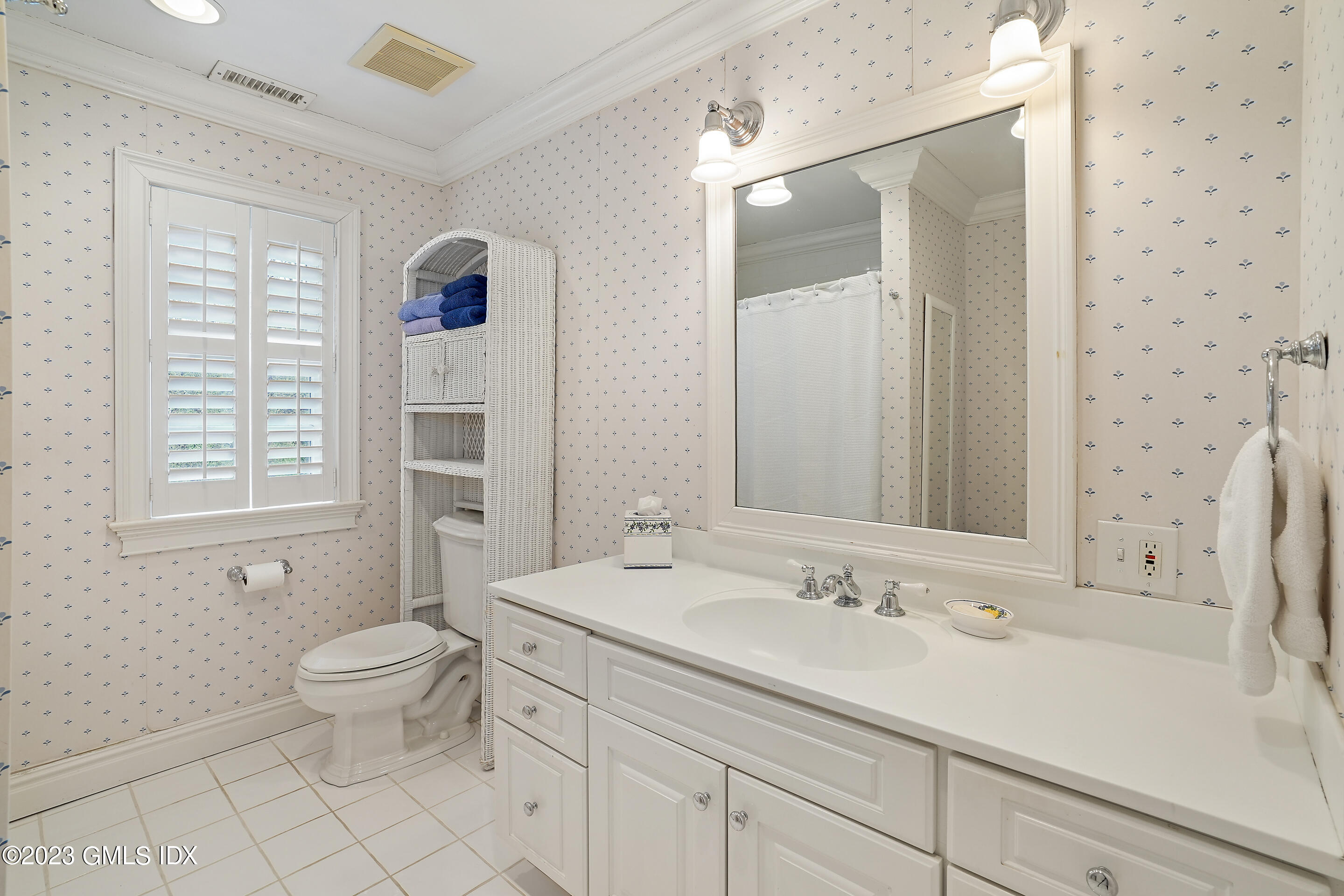 55 North Street Greenwich, CT 06830 - Photo 30 of 44 a bathroom with a sink a toilet and a large mirror