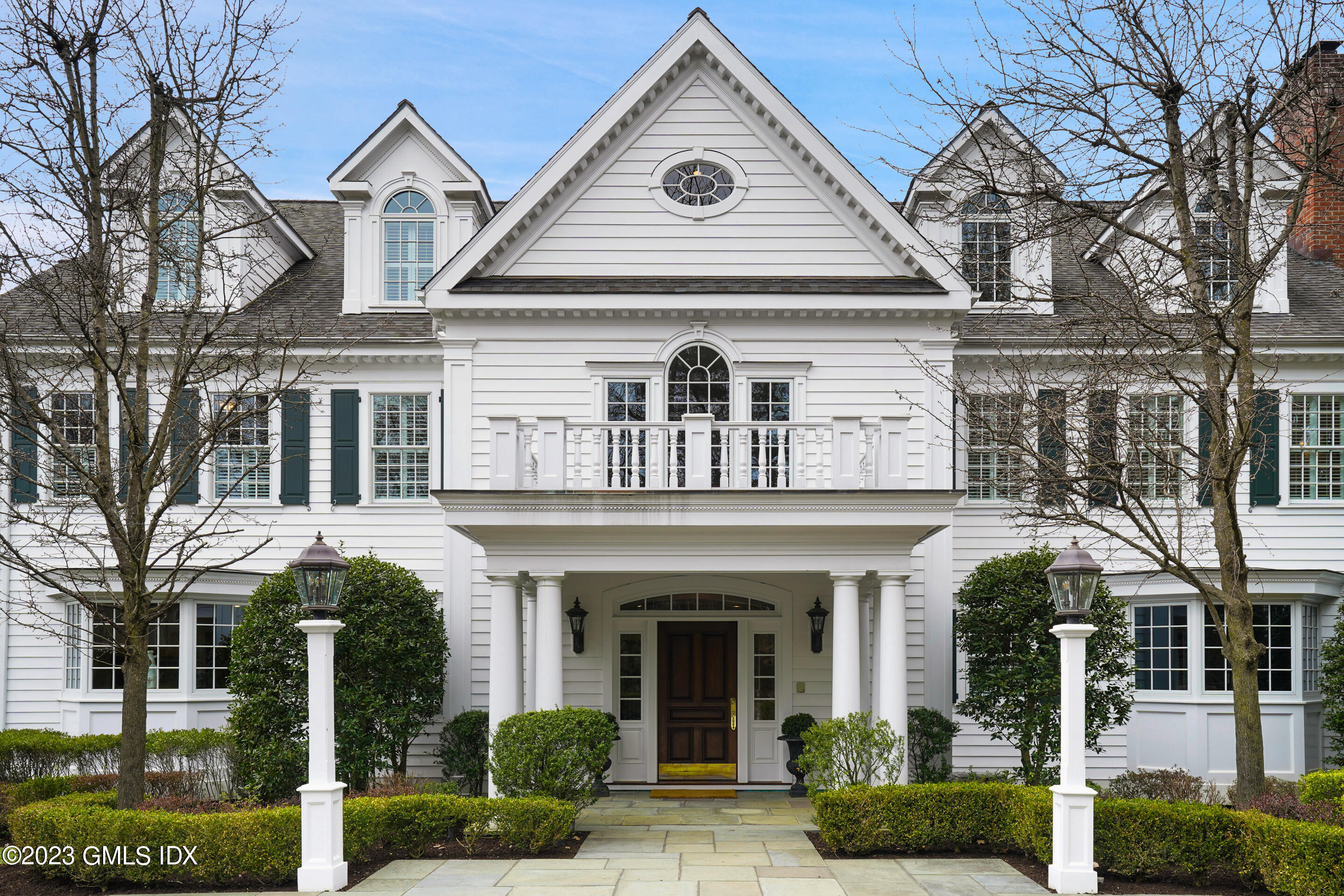 55 North Street Greenwich, CT 06830 - Photo 3 of 44 a front view of a house with a yard