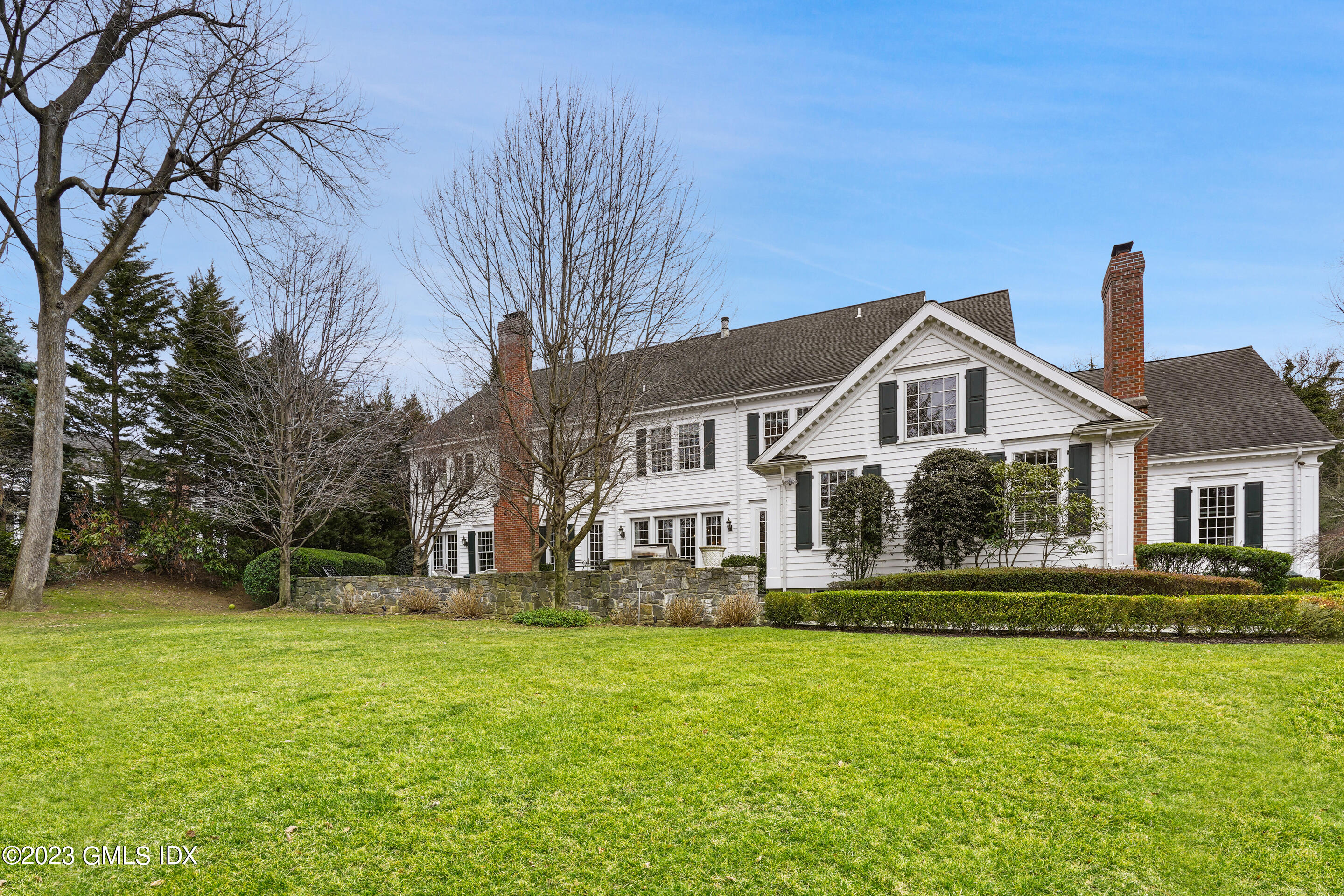 55 North Street Greenwich, CT 06830 - Photo 36 of 44 a front view of a house with a yard