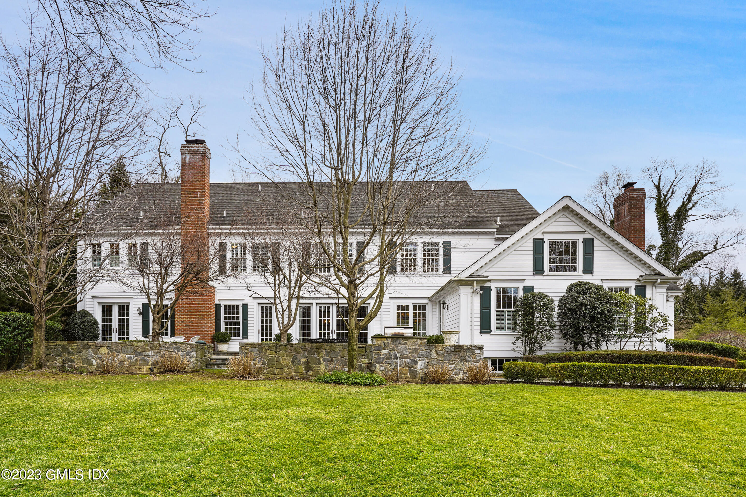 55 North Street Greenwich, CT 06830 - Photo 37 of 44 a view of a house with a big yard and large trees
